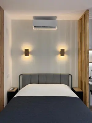 a bedroom with a bed and two lights on the wall at Apartamentos Nou Mestalla in Valencia