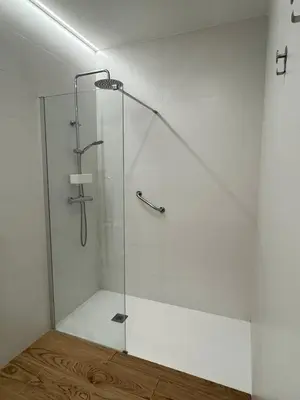 a shower with a glass door in a bathroom at Apartamentos Nou Mestalla in Valencia