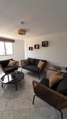 a living room with couches and chairs and a table at La Terracita de Carrica in Peñalba
