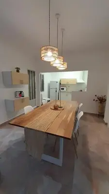 a dining room with a wooden table and chairs at La Terracita de Carrica in Peñalba
