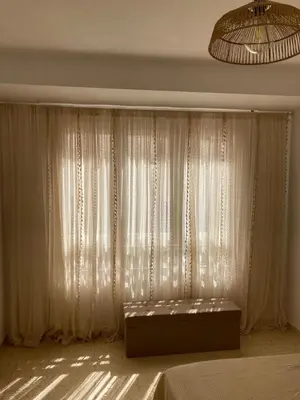 a bedroom with a bed and a window with curtains at La Terracita de Carrica in Peñalba