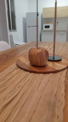 a wooden table with a wooden bowl on top of it at La Terracita de Carrica in Peñalba