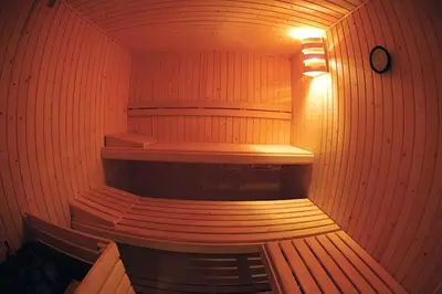 a wooden sauna with a wooden bench in it at Resort & Suites Ciudad de las Ciencias By VALENCIAFLATS EU in Valencia