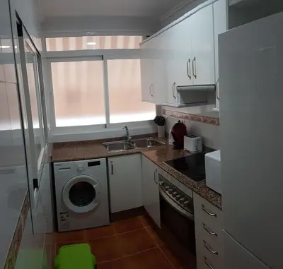 a small kitchen with a sink and a washing machine at Malva Arena in Valencia