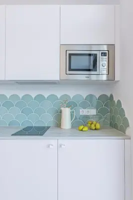 a kitchen with a microwave and a counter with fruit at Designer apartment facing the sea in Valencia