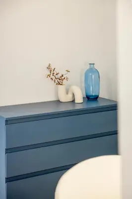 a blue dresser with a blue vase on top of it at Designer apartment facing the sea in Valencia