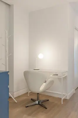 an office with a white desk and a white chair at Designer apartment facing the sea in Valencia