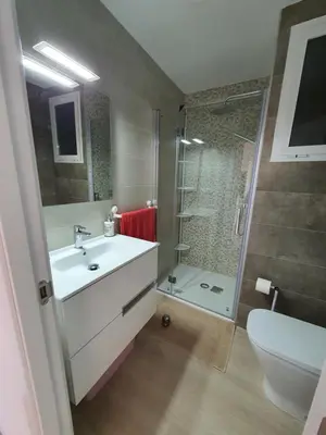 a bathroom with a sink and a shower and a toilet at Edificio JUNIOR in Cullera