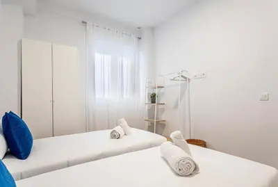 a white room with two beds and a mirror at Balandra, Lovely flat close to center in Valencia