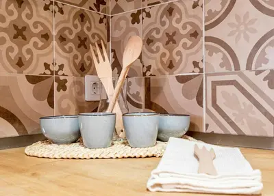 a table with three blue bowls and wooden utensils at Balandra, Lovely flat close to center in Valencia