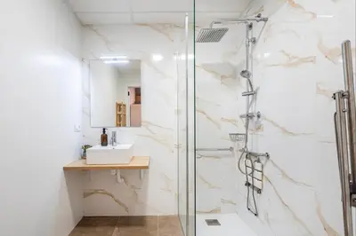 a bathroom with a glass shower and a sink at Balandra, Lovely flat close to center in Valencia
