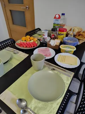 a table topped with white plates and bowls of food at Agui House in Valencia