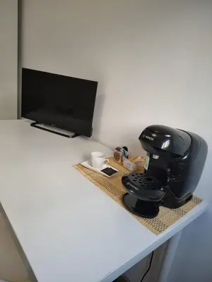 a desk with a coffee maker and a computer on it at Agui House in Valencia