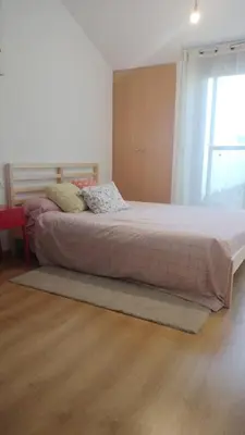 a large bed in a room with a large window at Alojamiento rural con encanto in Alborache