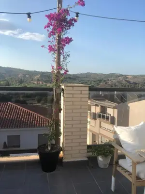 a balcony with a tree with pink flowers on it at Alojamiento rural con encanto in Alborache