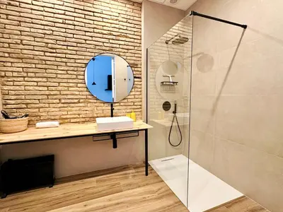 a bathroom with a shower and a sink and a mirror at Mediterranean Apartament in Valencia