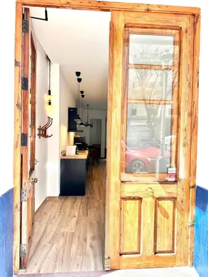 an open door into a living room with a red car at Mediterranean Apartament in Valencia