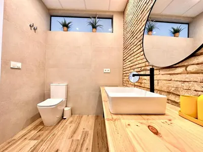 a bathroom with a sink and a toilet and a mirror at Mediterranean Apartament in Valencia