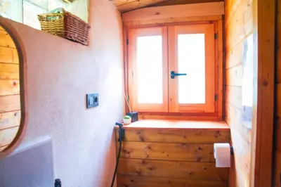 a hallway with a door and a window in a cabin at Cabaña madera en bosque 100 ECO in Petrés