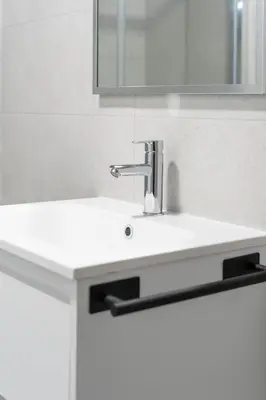 a sink in a bathroom with a mirror at VLC Host - Sumsi in Valencia