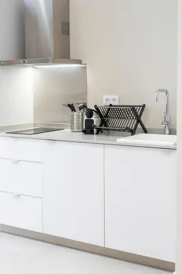 a kitchen with white cabinets and a sink at VLC Host - Sumsi in Valencia