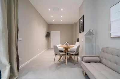 a living room with a table and chairs and a couch at VLC Host - Sumsi in Valencia