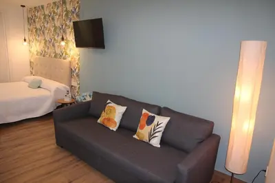 a living room with a couch and a bed at Ruzafa Acquamarina in Valencia
