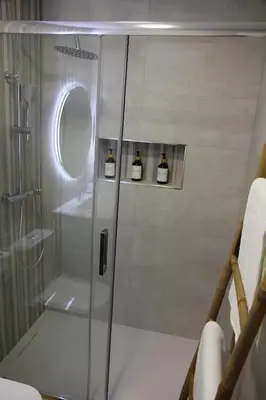 a shower with a glass door in a bathroom at Ruzafa Acquamarina in Valencia