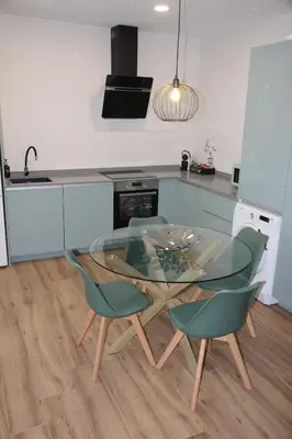 a kitchen with a glass table and two chairs at Ruzafa Acquamarina in Valencia