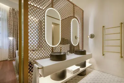 a hotel room with a bed and a mirror at Grand Hotel Centenari, Valencia, Autograph Collection in Valencia