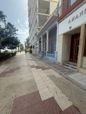 an empty street in a city with a building at Apartamento amanecer paseo marítimo in Cullera