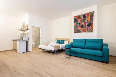 a living room with a blue couch and a chair at The Port Urban Loft in Valencia