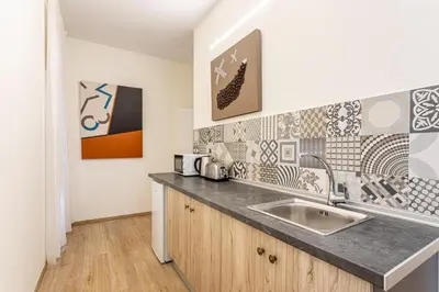 a kitchen with a sink and some art on the wall at The Port Urban Loft in Valencia
