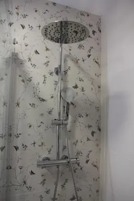 a shower in a bathroom with flowers on the wall at Ruzafa Tropical in Valencia