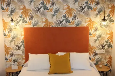 a bed with a headboard and two night stands at Ruzafa Tropical in Valencia