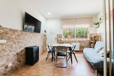 a living room with a table and a couch at Casa Las 4 Estaciones in Caudiel