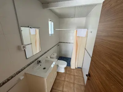 a bathroom with a toilet and a sink and a mirror at Camping Los Naranjos in Moncófar