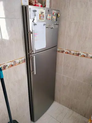 a stainless steel refrigerator in a corner of a kitchen at Calle platano37 in Valencia