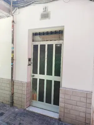 a door of a white building with green doors at Calle platano37 in Valencia