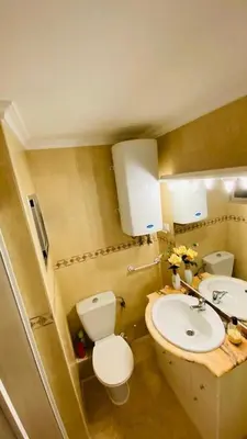 a bathroom with a toilet and a sink at Apartamento Bahía Cullera I in Cullera