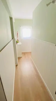 an empty room with white walls and a wooden floor at Apartamento Bahía Cullera I in Cullera