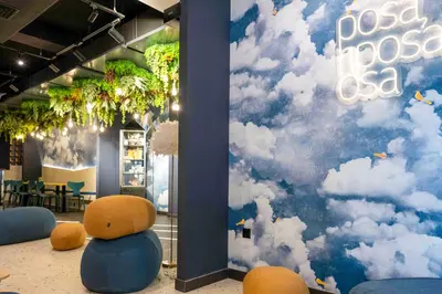 a room with a mural of clouds on the wall at Hotel Pathos by Mimood Aparthotels in Valencia