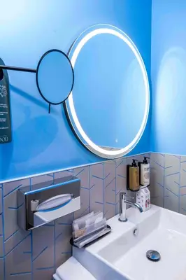 a bathroom with a sink and a mirror at Hotel Pathos by Mimood Aparthotels in Valencia