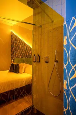 a bathroom with a shower and a bed in a room at Hotel Pathos by Mimood Aparthotels in Valencia