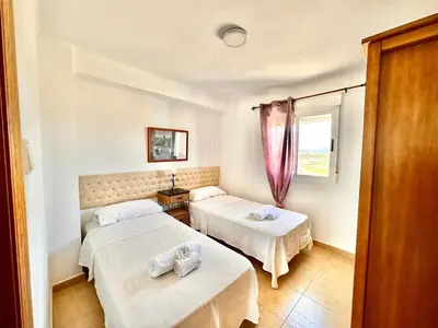a room with two beds and a window at Vistas al mar, El Puig in El Puig