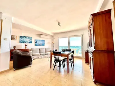 a living room with a table and chairs and a couch at Vistas al mar, El Puig in El Puig
