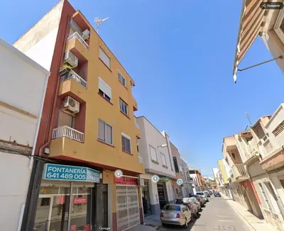 a yellow building on a street with parked cars at Sagunto Beach Apartment 500m to Sea, WiFi 600Mb y AC in Puerto de Sagunto