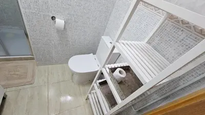a small bathroom with a toilet and a shower at Sagunto Beach Apartment 500m to Sea, WiFi 600Mb y AC in Puerto de Sagunto