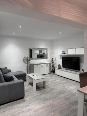a living room with a couch and a tv at Cullera Sea and Mountain Balcony in Cullera