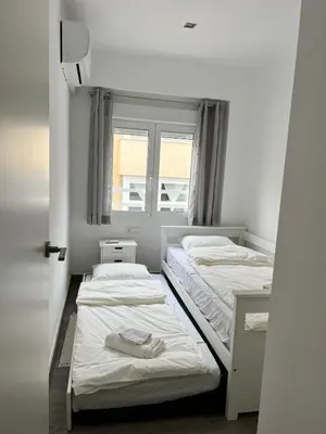 two beds in a small room with a window at Cullera Sea and Mountain Balcony in Cullera